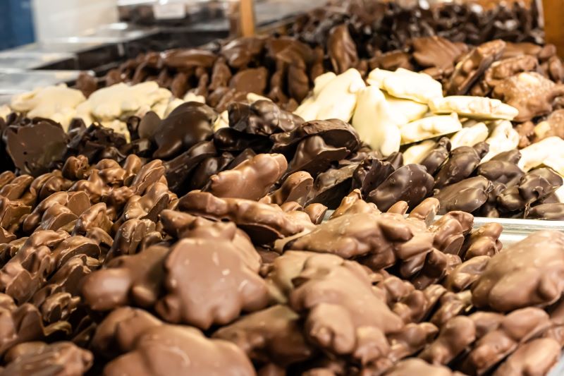 White, Dark and Milk Chocolate Snappers sitting on trays in a case at hansel and gretel candy kitchen helen georgia
