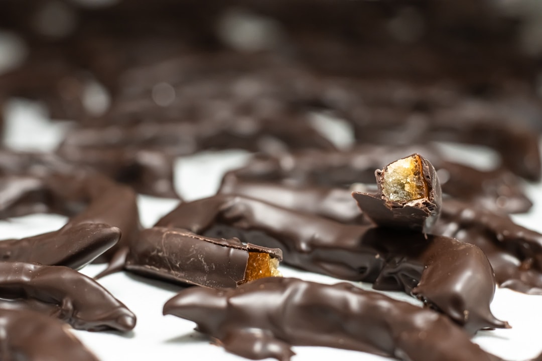 Dark Chocolate Covered Orange Peel on a cooling tray at hansel and gretel candy kitchen