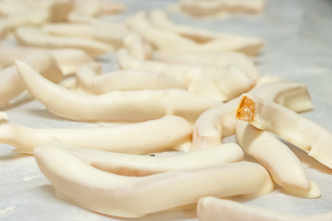 White Chocolate Covered Orange Peel on a cooling tray at hansel and gretel candy kitchen