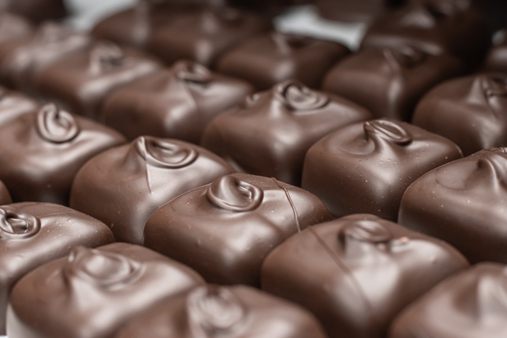 Multiple Rows of Chocolate Covered Toffees cooling from Hansel and Gretel Candy Kitchen, Helen Georgia
