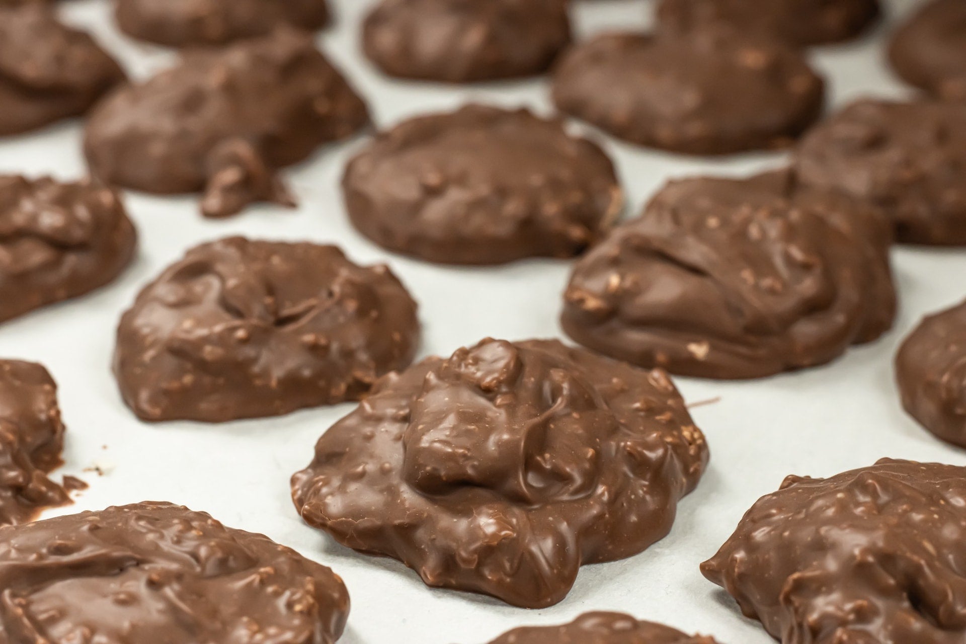 Milk Chocolate Cashew Clusters cooling on a tray at hansel and Gretel Candy Kitchen, Helen Georgai