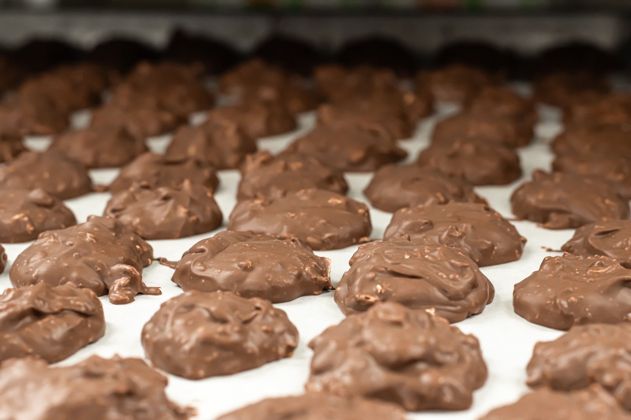 Pecan Milk Chocolate Clusters Sitting on a cooling tray to cool