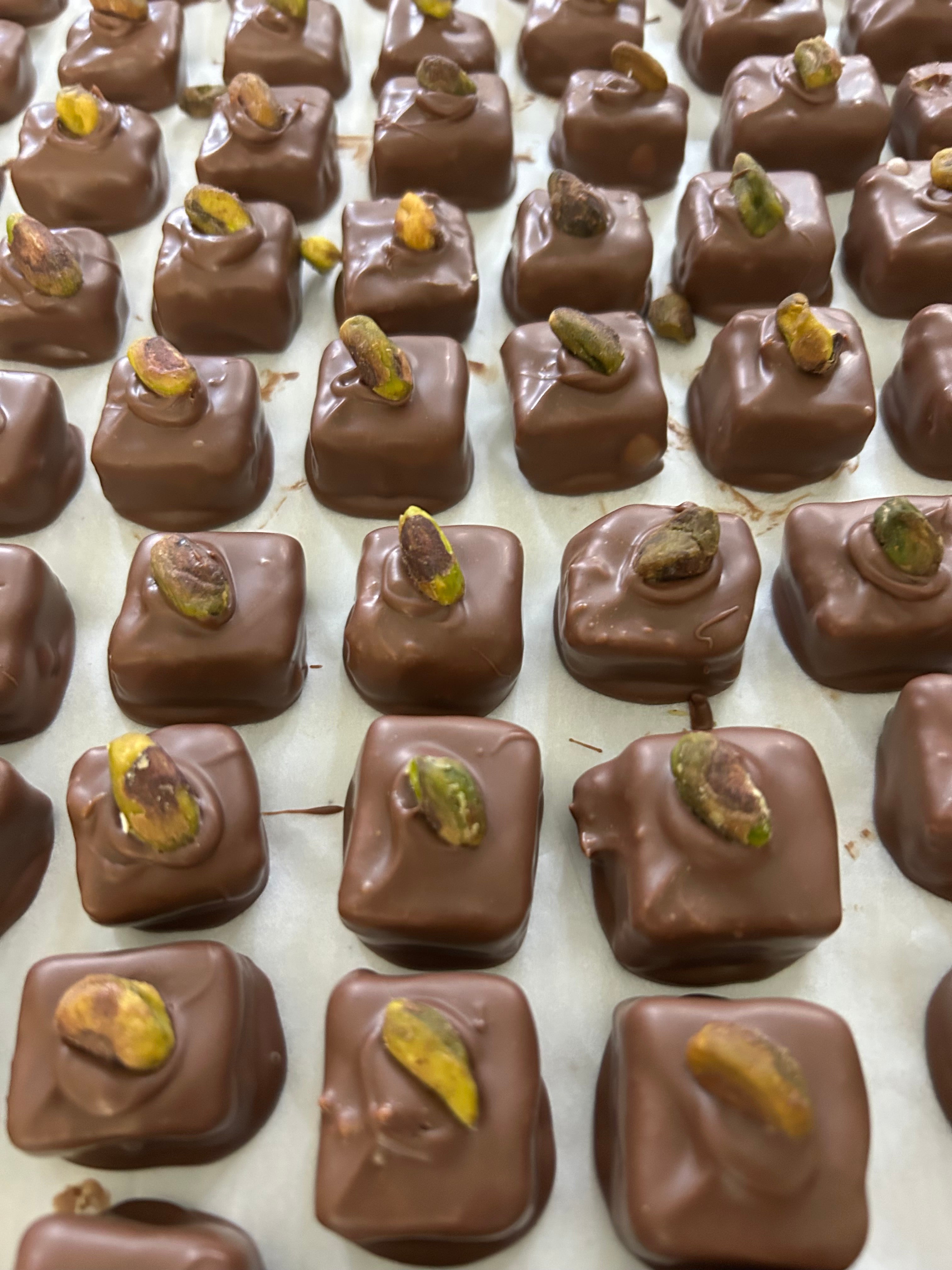 Dubai Chocolate candies with pistachios on a cooling tray