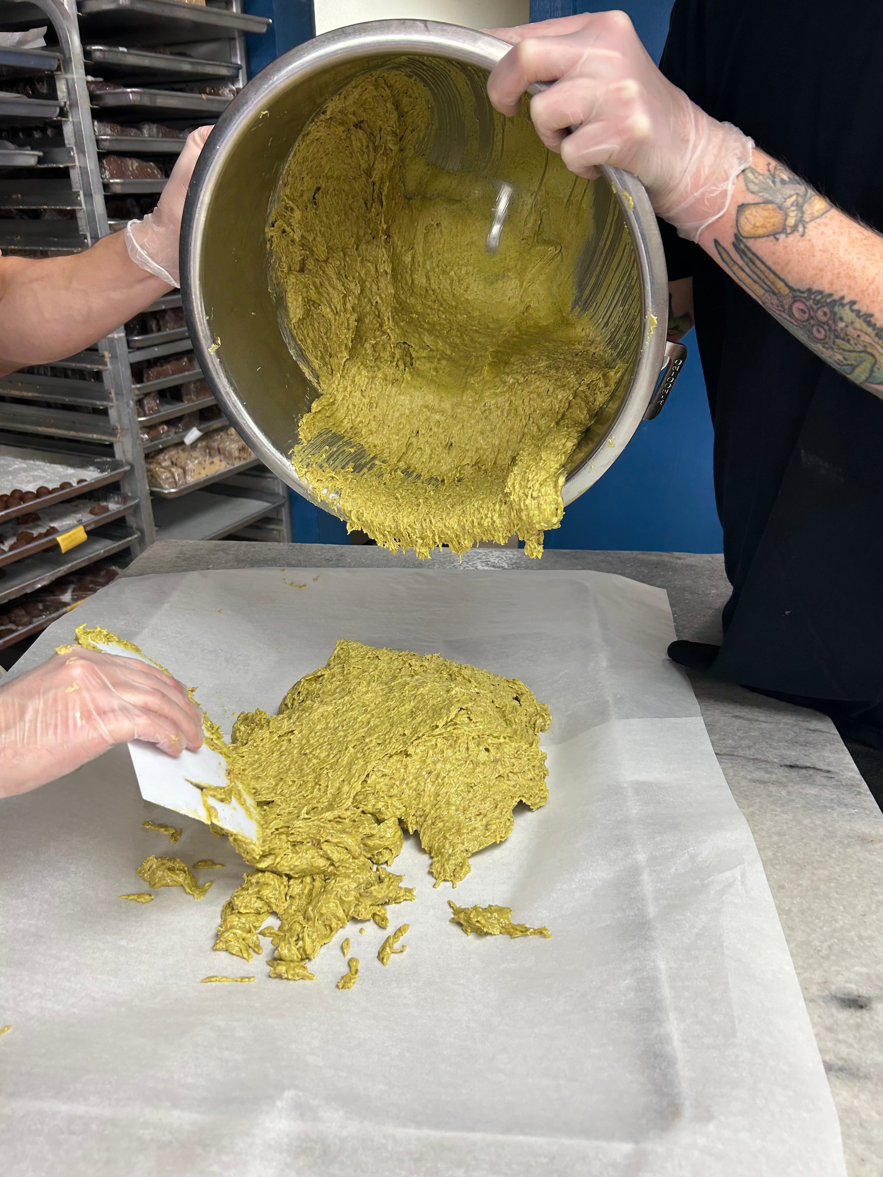 pistachio filling being transferred to a tray for cooling