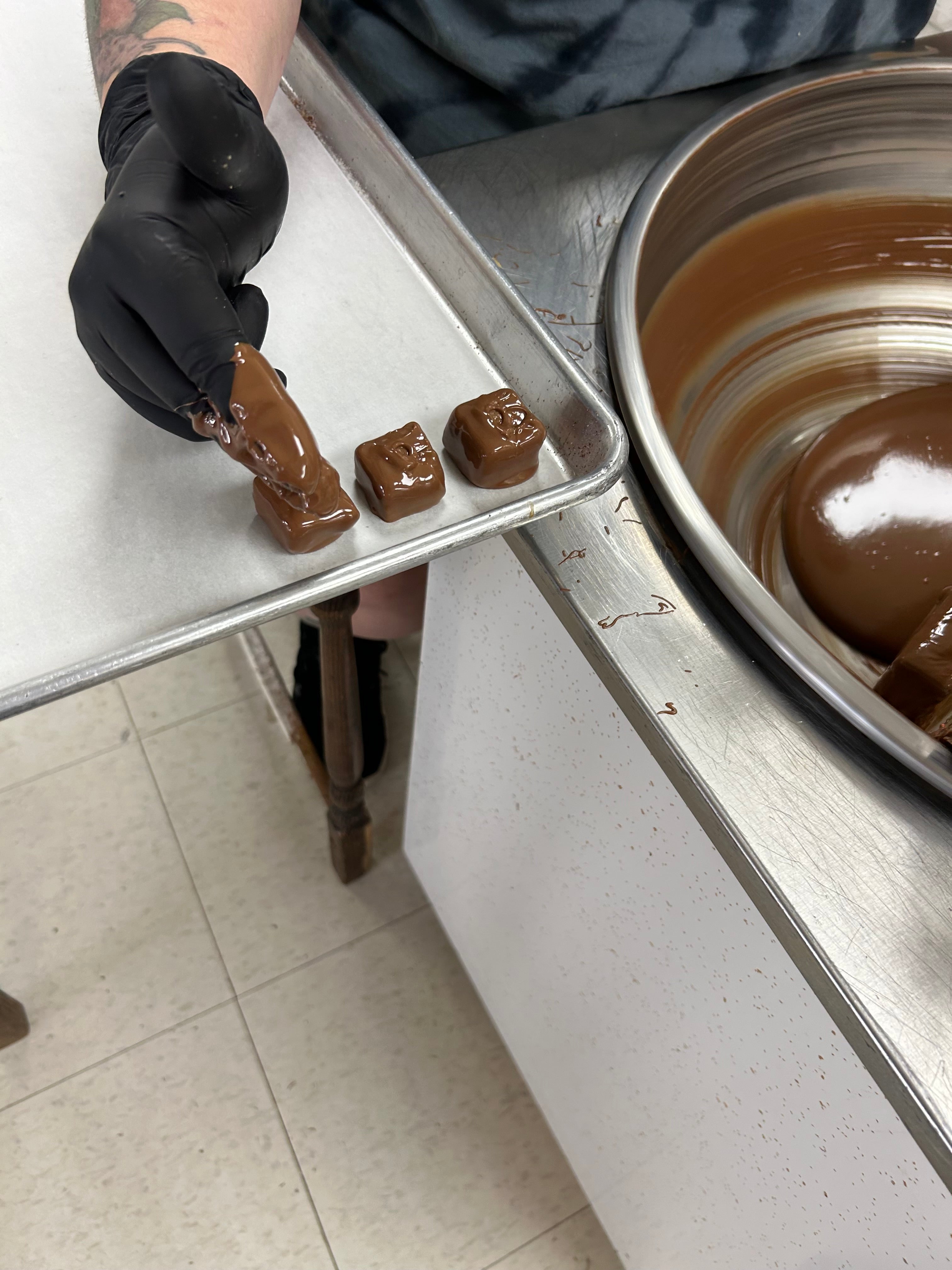 Dubai Chocolates after being covered in chocolate and set on a cooling tray at hansel and gretel candy kitchen