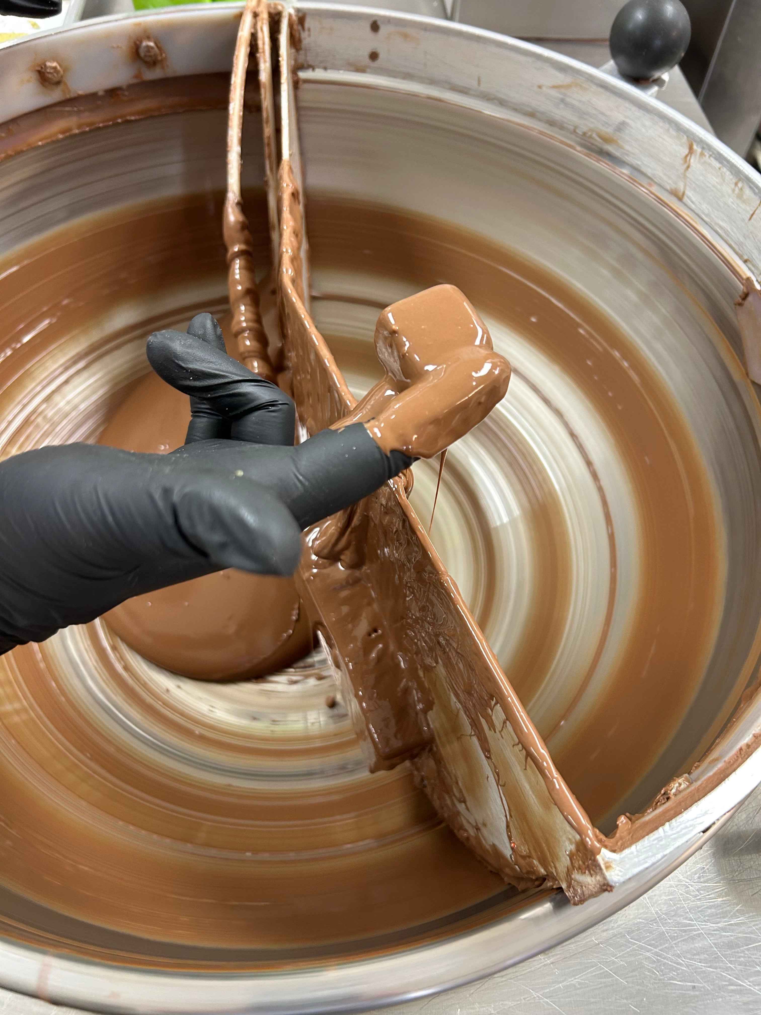pistachio paste being coated in chocolate to make a Dubai chocolate at Hansel and Gretel candy kitchen 
