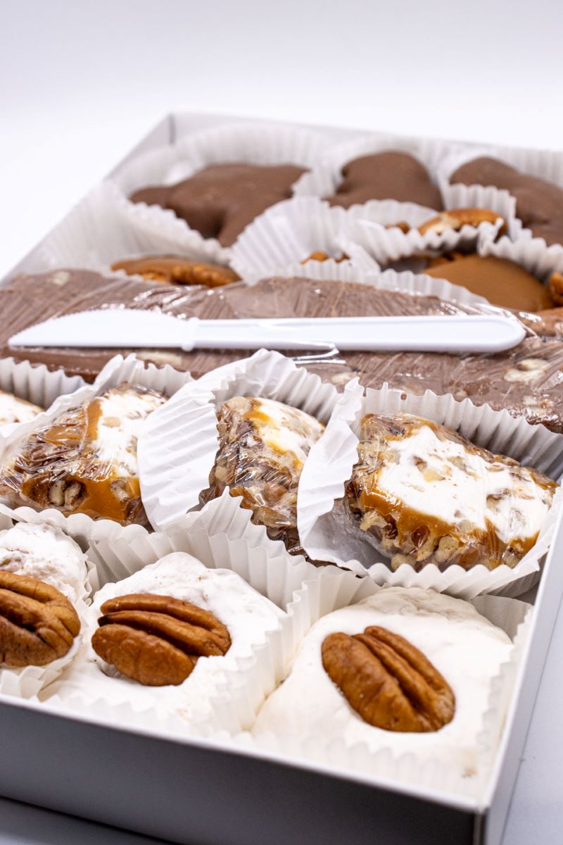 Pecan Lovers Delight box open showing multiple pecan chocolates from Hansel and Gretel Candy Kitchen Helen georgia