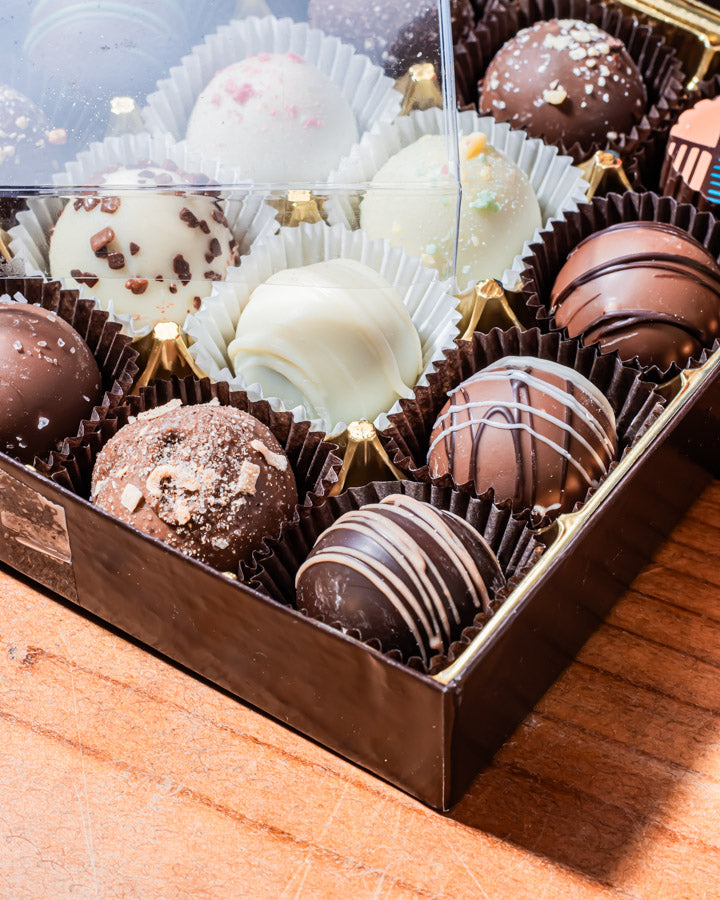 16pc Custom Truffle Box with the lid on the top of the box to the side from Hansel and Gretel Candy Kitchen Helen Georgia